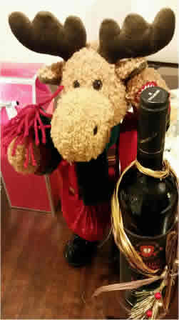 Plush reindeer with bottle of wine