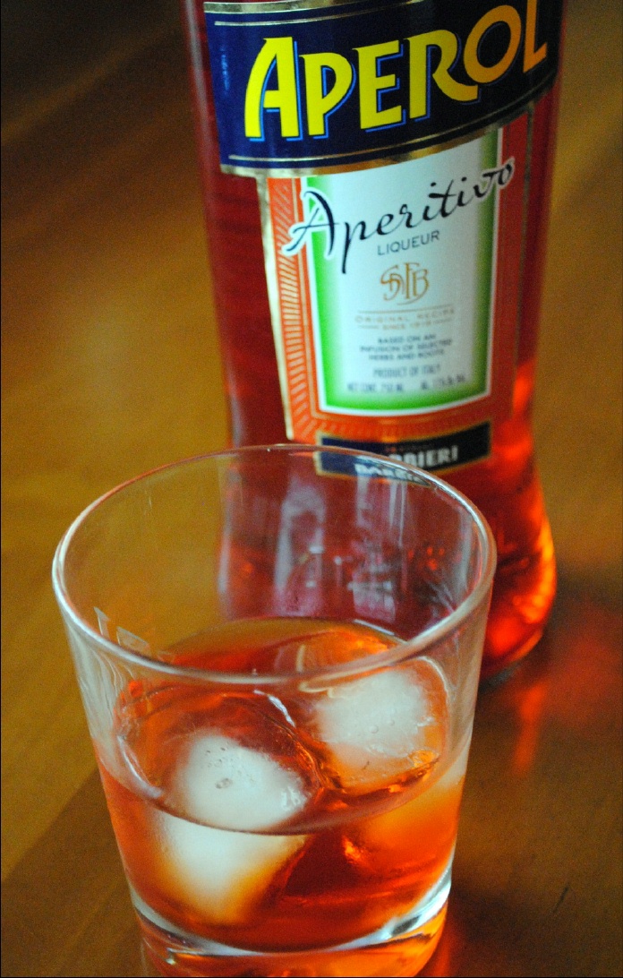 Aperol bottle with a glass of Aperol on the rocks.