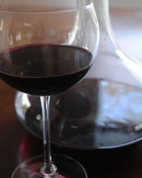 glass of red wine with decanter
